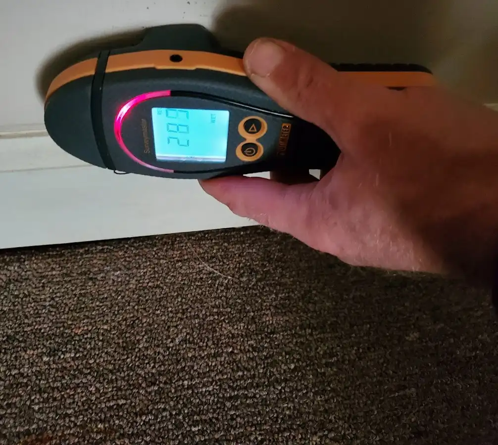 Moisture detection at baseboard during Storm Damage Restoration in Hermantown
